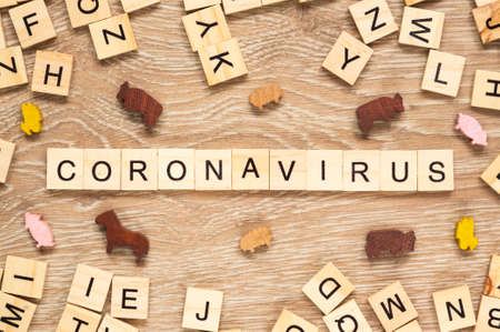 The word "Coronavirus" spelt out with letter tiles on the wooden backgroundの写真素材