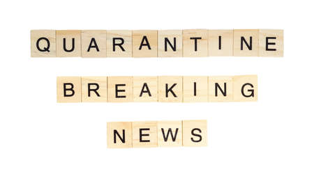 The words "Quarantine Breaking News" spelt out with letter tiles on the white backgroundの写真素材