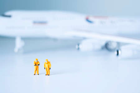 Group of toy scientists isolate a plane and its passengers. Quarantine or toxic person isolation...