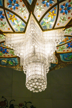 Close-up of one of the exquisite chandeliers inside the Sheikh Zayed Grand Mosque, adorned with millions of Swarovski crystals.の写真素材