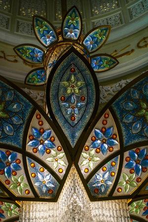 Close-up of one of the exquisite chandeliers inside the Sheikh Zayed Grand Mosque, adorned with millions of Swarovski crystals.の写真素材