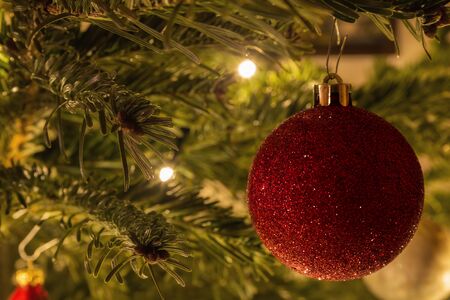 Christmas bauble is hanging on the treeの写真素材