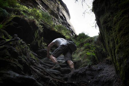 Someone is climbing up the stonesの写真素材