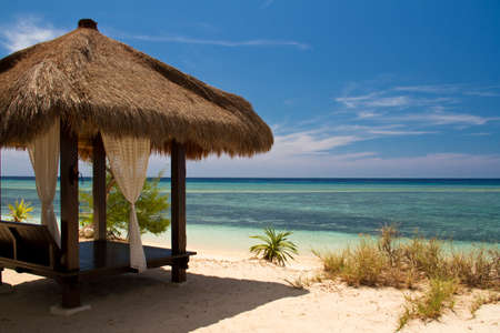 Hut at beach and turquoise sea on island, Gili Islandsの写真素材