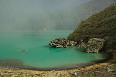 Yellow sulfur mine with blue lake inside volcano, Ijen Plateauの写真素材