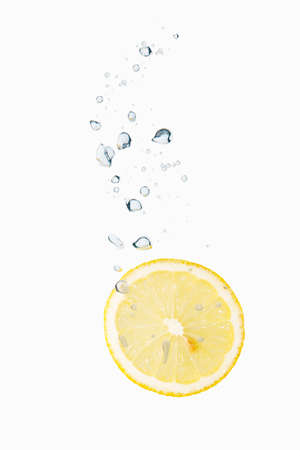 Lemon in water with air bubblesの写真素材