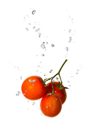 Cherry tomato in water with air bubblesの写真素材
