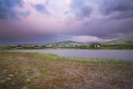 Huts on lake in landscape of Norwayの写真素材