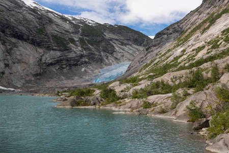 Blue glacier with lake Nigardsbreen in Norwayの写真素材