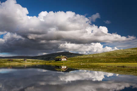 Huts on lake in landscape of Norwayの写真素材
