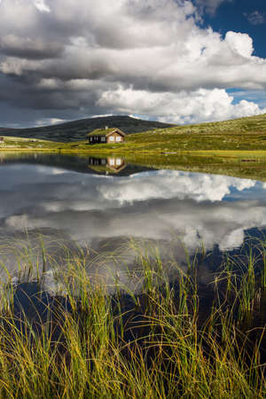 Huts on lake in landscape of Norwayの写真素材