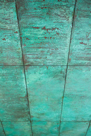 Weathered, oxidized copper wall structure in greenの写真素材