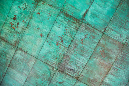 Weathered, oxidized copper wall structure in greenの写真素材