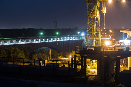 Construction of the bridge against the evening of the city, ?onstruction site on the sunset.の写真素材