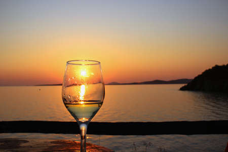 Glass of wine at sunsetの写真素材