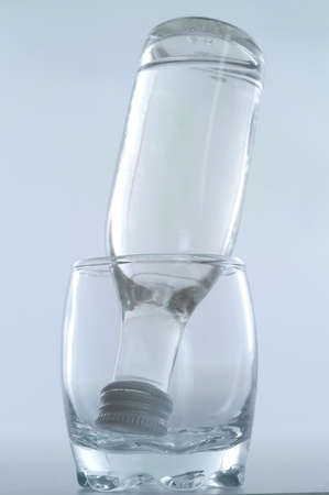 bottle of vodka inside glassの写真素材