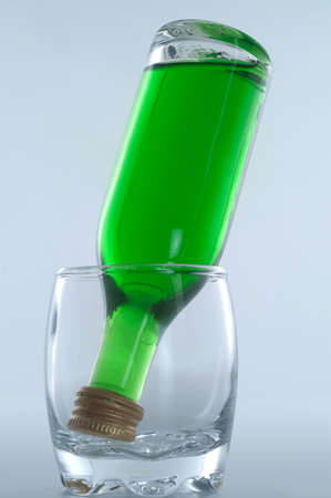 bottle of liqueur inside glassの写真素材