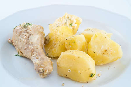 chicken with potato on the plateの写真素材