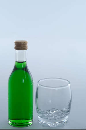 bottle of liqueur with glassの写真素材