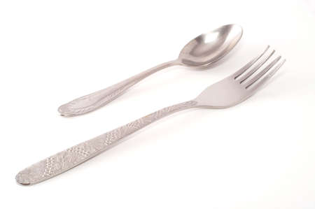 metallic spoon and fork isolated on whiteの写真素材