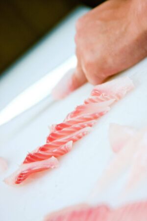 With a knife carefully cut fillets of salmonの写真素材