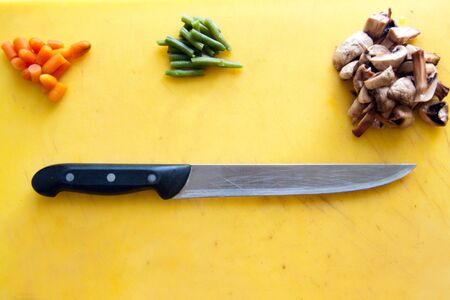 ingredients for cooking and knife are on the cutting boardの写真素材