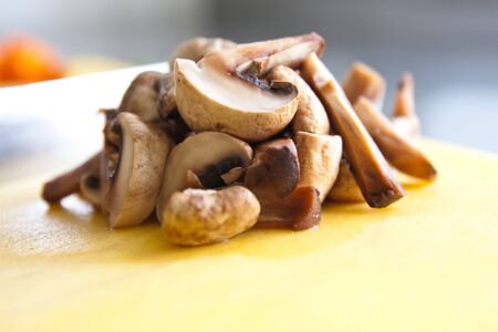 bunch of mushrooms on a cutting boardの写真素材
