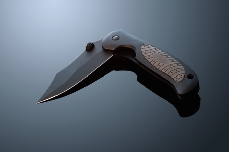 Battle metal folding knife on the background gradientの写真素材
