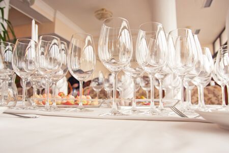 Serving luxury glass goblets on table in restaurantの写真素材
