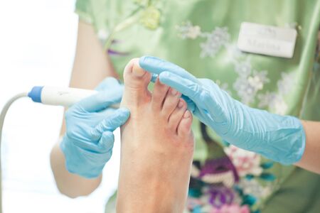 Peeling feet pedicure procedure in a beauty salon pediicureの写真素材