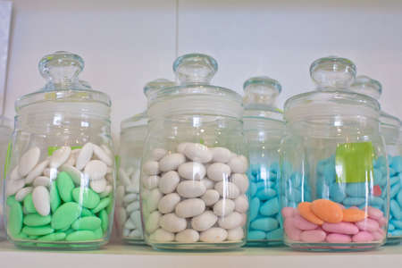 vintage drugstore glass jar with colored pillsの写真素材