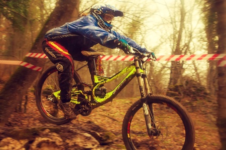 Rider jumping on mountain bike in the woods in bad weatherのeditorial素材