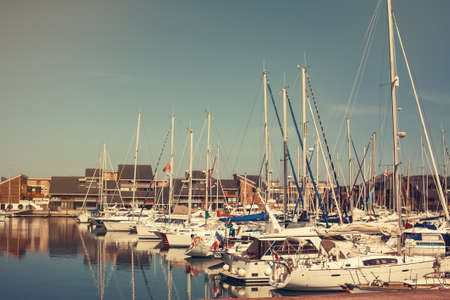 Yachts moored in the bay in the rays of the sunの写真素材