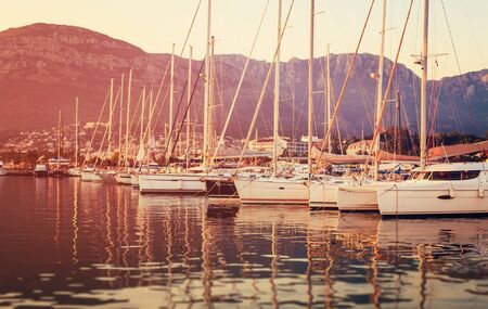 Yachts moored in the bay in the rays of the sunset
