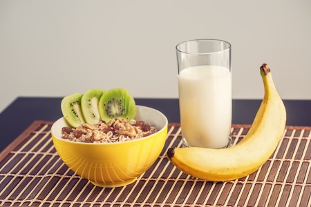 Healthy breakfast with fruit, milk and porridge in a retro styleの写真素材