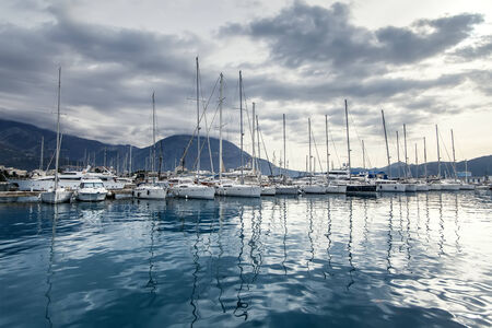 Beautiful illustration with yachts in the bay. Luxury boats and reflection in water.の写真素材