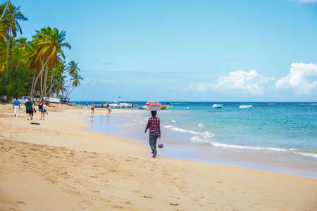 Local Salesman with goods on the head on the caribbean beach. Punta Cana, Dominican Republicの写真素材