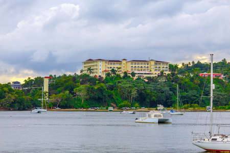 luxury vacation on catamaran near green shore with beautiful architectureの写真素材