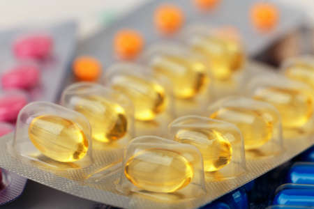 close-up of yellow medical pills or tablets in blister. pharmaceuticsの写真素材