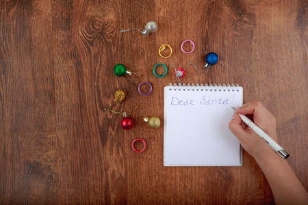 writing of letter to Santa Claus on decorated wooden table with space for text on the leftの写真素材