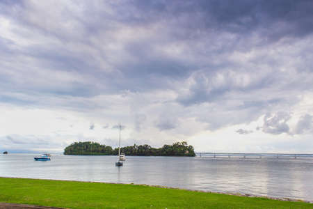 sail boats near the cost with palm trees in cloudy weather. Samana, Dominican Republic