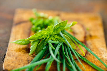 green onion and mint on a wooden Board. Fresh greens on blured wood backgroundの写真素材