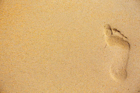 Vacation concept. trail foot, footprint on the sand