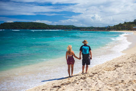 loving couple of travelers holding hands walk on a Caribbean beach. Dominican Republic. Vacation conceptの写真素材