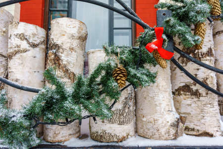 Christmas winter external decorations. Wooden stumps with green spruce branches and red ribbonsの写真素材