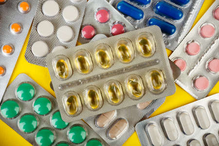 pharmaceutical industry, a group of different colorful pills in blister packsの写真素材