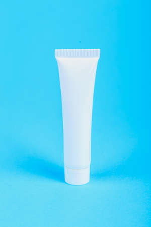 one white cream tube with copy space on blue backgroundの写真素材