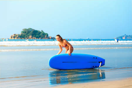 white blonde surfer girl  bikini with surfboard goes to seaの写真素材