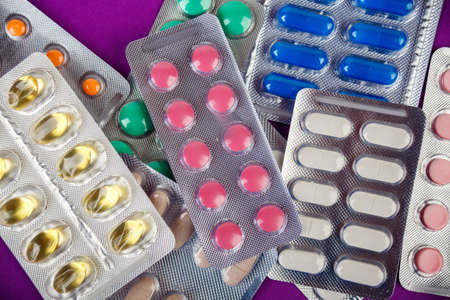 pharmaceutical industry, group of different colorful pills in blister packsの写真素材