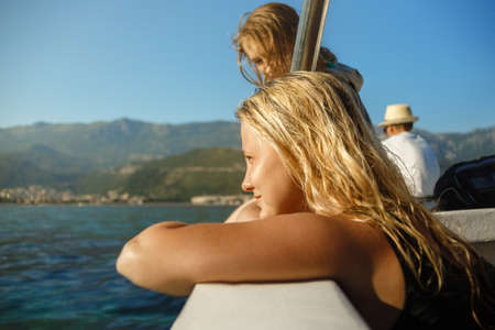 young beautiful girl on a yacht looks at the sea